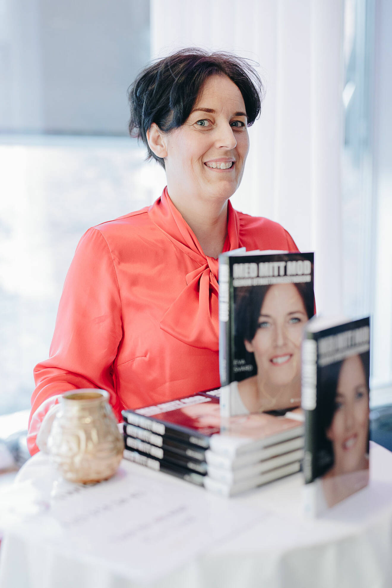 Eva Svärd med sin bok "Med mitt mod genom utmattningssyndrom"