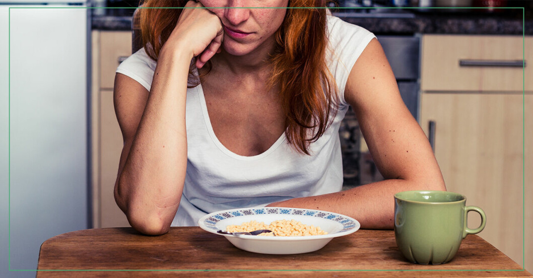 deprimerad kvinna vid köksbord