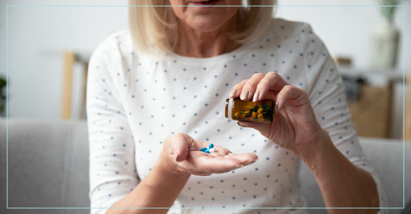 kvinna tar smärtstillande tabletter